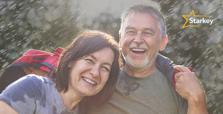 Man and woman in rain wearing waterproof Starkey hearing aids