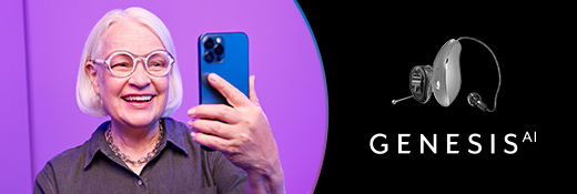 Image of woman looking at phone and wearing Genesis AI hearing aids